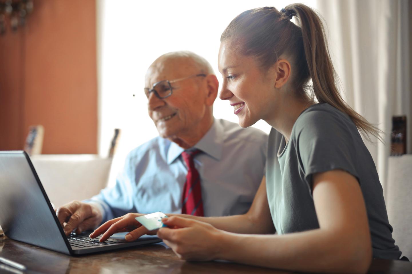 young woman old man computer
