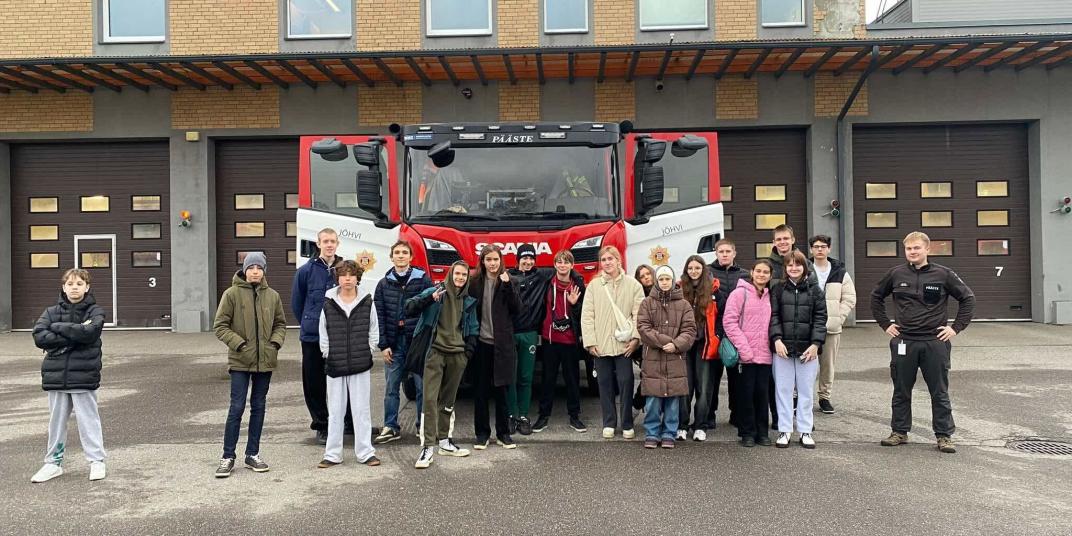 refugee youth infront of a firetruck 