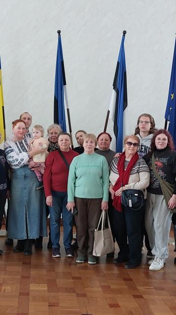 People standing infront of flags