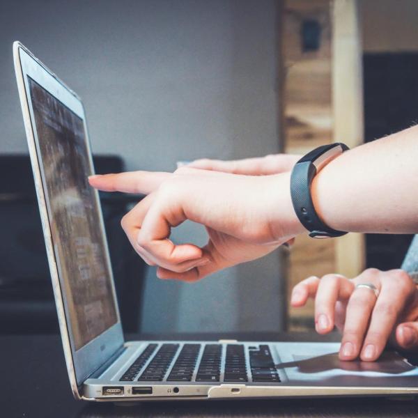 lap top finger pointing to screen